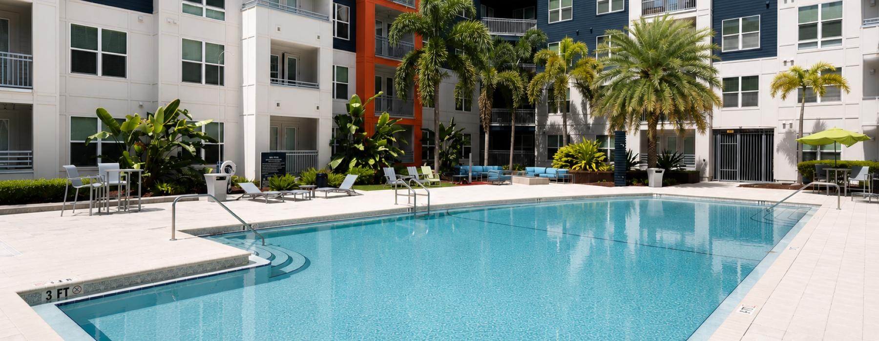 Resort-style swimming pool with lounge seating