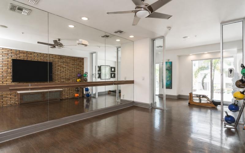 a large room with a fireplace and a wood floor